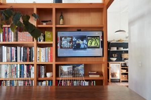 Bookshelf with a television incorporated for a creative touch on an office space